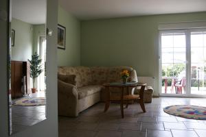 a living room with a couch and a table at Villa Justina in Charzykowy