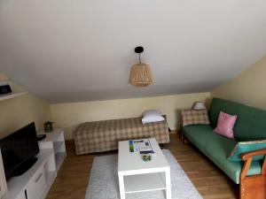 a living room with a couch and a tv at La Gaviota in Ferrol