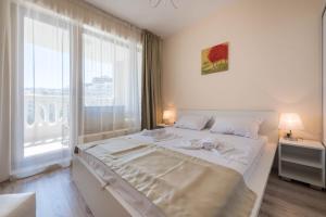Ένα ή περισσότερα κρεβάτια σε δωμάτιο στο Blue Lagoon Seafront Apartments +39 φωτογραφίες