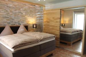 a bedroom with two beds and a mirror at Ferienwohnung An der alten Stadtmauer in Annaberg-Buchholz +34 photos
