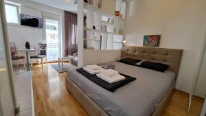 a bedroom with a large bed with towels on it at Maya 's home - Vracar in Vračar (historical)