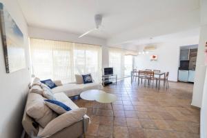 a living room with a couch and a table at Felicia Dream House in Kamena Vourla