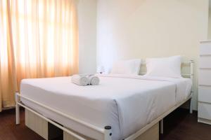 Postel nebo postele na pokoji v ubytování Spacious 2BR at Grand Asia Afrika Apartment By Travelio + 12 fotografií