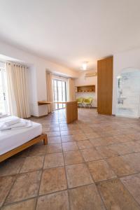 a large room with a bed and chairs in it at Felicia Dream House in Kamena Vourla +86 photos