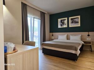 a hotel room with a bed and a window at Casa Calfelor Kolping Timișoara in Timişoara