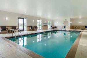 a large pool with blue water in a hotel room at Sleep Inn & Suites Grand Forks Near Alerus Center in Grand Forks