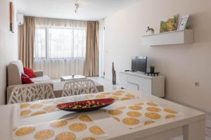 a living room with a table with a bowl of food on it at Seaside Apartment in Varna City