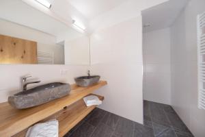 a bathroom with a stone sink and a mirror at Edelweisshaus Top 2 in Königsleiten +24 photos