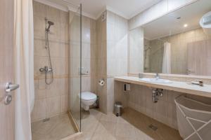 a bathroom with a shower and a toilet and a sink at Seaside Apartment in Varna City +20 photos