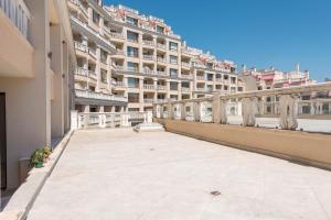 a large apartment building with a large balcony at Seaside Apartment in Varna City