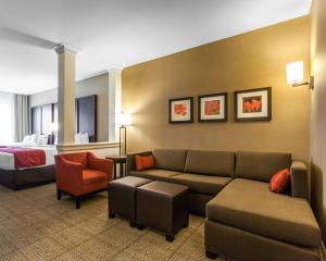 a hotel room with a couch and a bed at Comfort Suites-Youngstown North in Youngstown