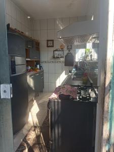 a kitchen with a sink and a stove at Casa primavera in São Pedro da Aldeia