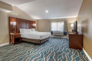 a hotel room with a bed and a television at Comfort Inn Asheville East-Blue Ridge Pkwy Access in Asheville +37 photos