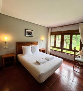 Postel nebo postele na pokoji v ubytování Hotel Pugide