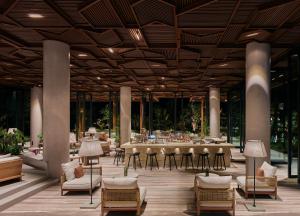 a large dining room with a long table and chairs at Maxx Royal Bodrum in Golturkbuku