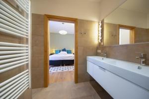 a bathroom with a tub and a bedroom with a bed at Edelweisshaus Top 5 in Königsleiten +29 photos