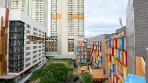 an overhead view of a city with tall buildings at Studio Loft No Kitchen Mezzanine at Kubikahomy Apartment By Travelio in Tangerang