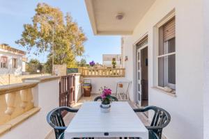 a white table and chairs on a balcony with a view at Meliso in Leuca