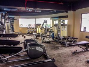 a gym with treadmills and machines in a room at Homey and Comfort Stay Studio Atria Residences Gading Serpong Apartment By Travelio in Tangerang