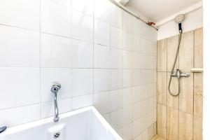 a bathroom with a bath tub and a shower at Meliso in Leuca +28 photos