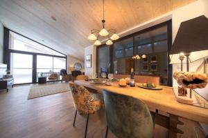 a dining room and living room with a table and chairs at Edelweisshaus Top 15 in Königsleiten