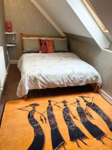 a bedroom with a bed with a rug on the floor at Crescent Loft Apartment - 1 bed in Goodmayes