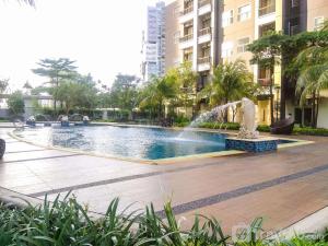 当格浪Fully Furnished with Comfortable Design 1BR Apartment Silkwood Residences By Travelio的城市里有喷泉的游泳池