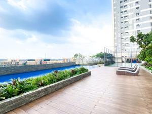 a balcony of a building with a view of a river at Comfortable and Strategic 1BR at Vasanta Innopark Apartment By Travelio in Cikarang
