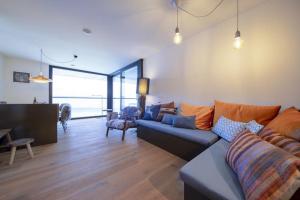 a living room with a couch and a table at Edelweisshaus Top 14 in Königsleiten