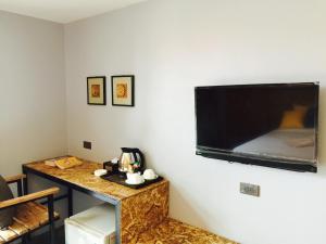 a large flat screen tv hanging on a wall at The Hip Resort @ Phi Phi in Phi Phi Islands
