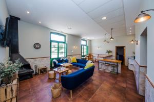 un salon avec un canapé bleu et une table dans l'établissement Hotel Rural Estación de la Dehesa, à Almazán