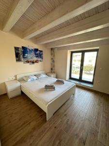 a bedroom with a large bed and a large window at Villa Stephanie in Hanioti