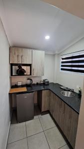 a kitchen with a sink and a counter top at First 2 Stay in Germiston