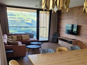a living room with a couch and a tv at Edelweisshaus Top 12 in Königsleiten