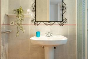 a bathroom with a sink and a mirror at Sa Tanca Es Pujols in Es Pujols +18 photos