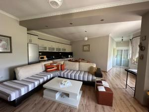 a living room with a couch and a table at ADA's Guest House in Gjirokastër