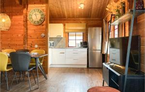 a kitchen with a table and a clock on the wall at Gorgeous Home In Gramsbergen With Wifi in Gramsbergen