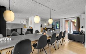 Un comedor y una sala de estar con mesa y sillas. en Lovely Home In Ulfborg With Sauna, en Ulfborg
