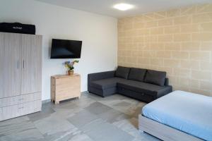 Et tv og/eller underholdning på Casa Vacanza Mario 2D a 180 mt dal mare di Punta Prosciutto