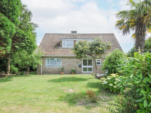 a house with a palm tree and a yard at Sea Drift in St Austell
