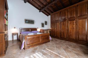 a bedroom with a bed and wooden cabinets at Casaletto della musica in Viterbo