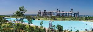 a large swimming pool in front of a large building at Steyn City Hotel by Saxon in Midrand