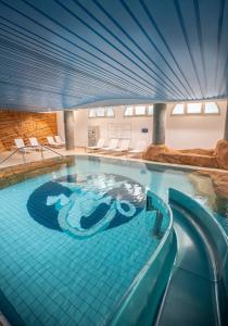 a pool in a hotel with a swimming pool at Dream Castle Hotel Marne La Vallee in Magny-le-Hongre