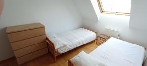 a small bedroom with a bed and a dresser at EnBURELA Confort y Relax in Burela de Cabo