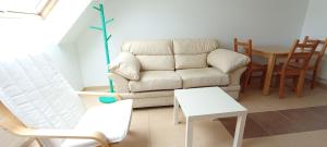 a living room with a couch and a table at EnBURELA Confort y Relax in Burela de Cabo +13 photos