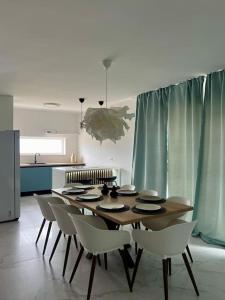 a dining room table and chairs in a kitchen at Holiday Home Mak in Ražanac