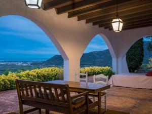 a table and chairs on a patio with a view at House -Sleeps 8-Natural Pool-Pet Friendly in Artana