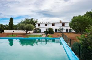 a large swimming pool in front of a house at House -Sleeps 8-Natural Pool-Pet Friendly in Artana