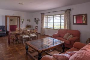 a living room with a couch and a table at House -Sleeps 8-Natural Pool-Pet Friendly in Artana +15 photos