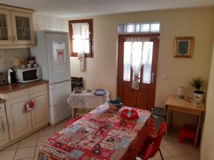 a kitchen with a table with a red table cloth on it at Appartement avec jardin privé à Montreux 100mt du lac in Montreux +69 photos